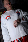 White long-sleeve shirt with DriftCave chest logo and blue flame emblem near shoulder