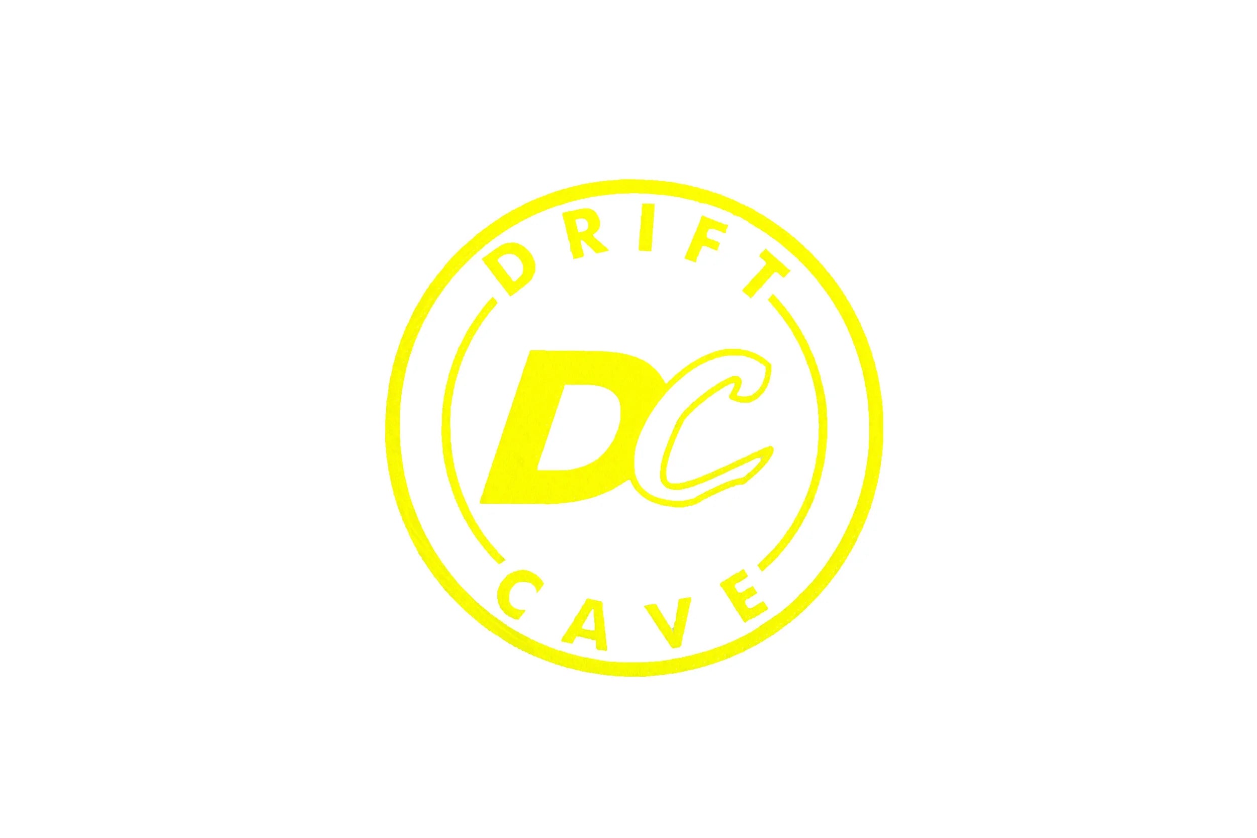 Round sticker with DC CAVE logo, neon yellow outline and yellow letters