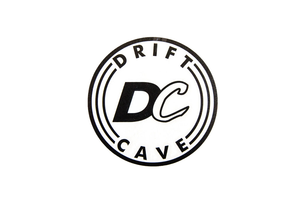 Round sticker with DC CAVE logo, black outline and white background