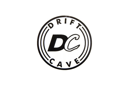 Round sticker with DC CAVE logo, black outline and white background