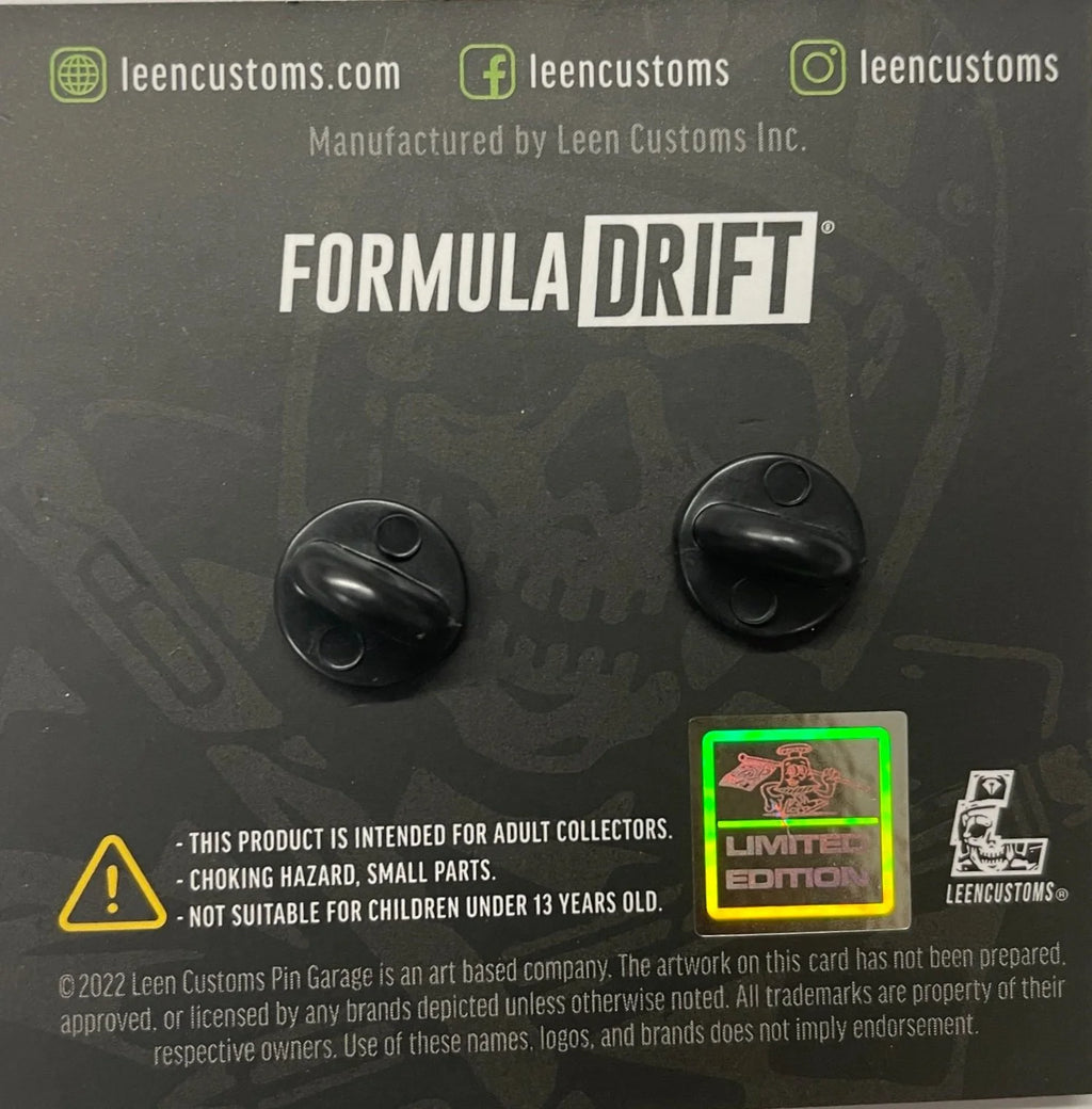 Two round Formula Drift limited edition enamel pins displayed on a card