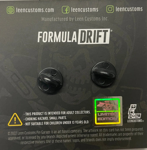Two round Formula Drift limited edition enamel pins displayed on a card