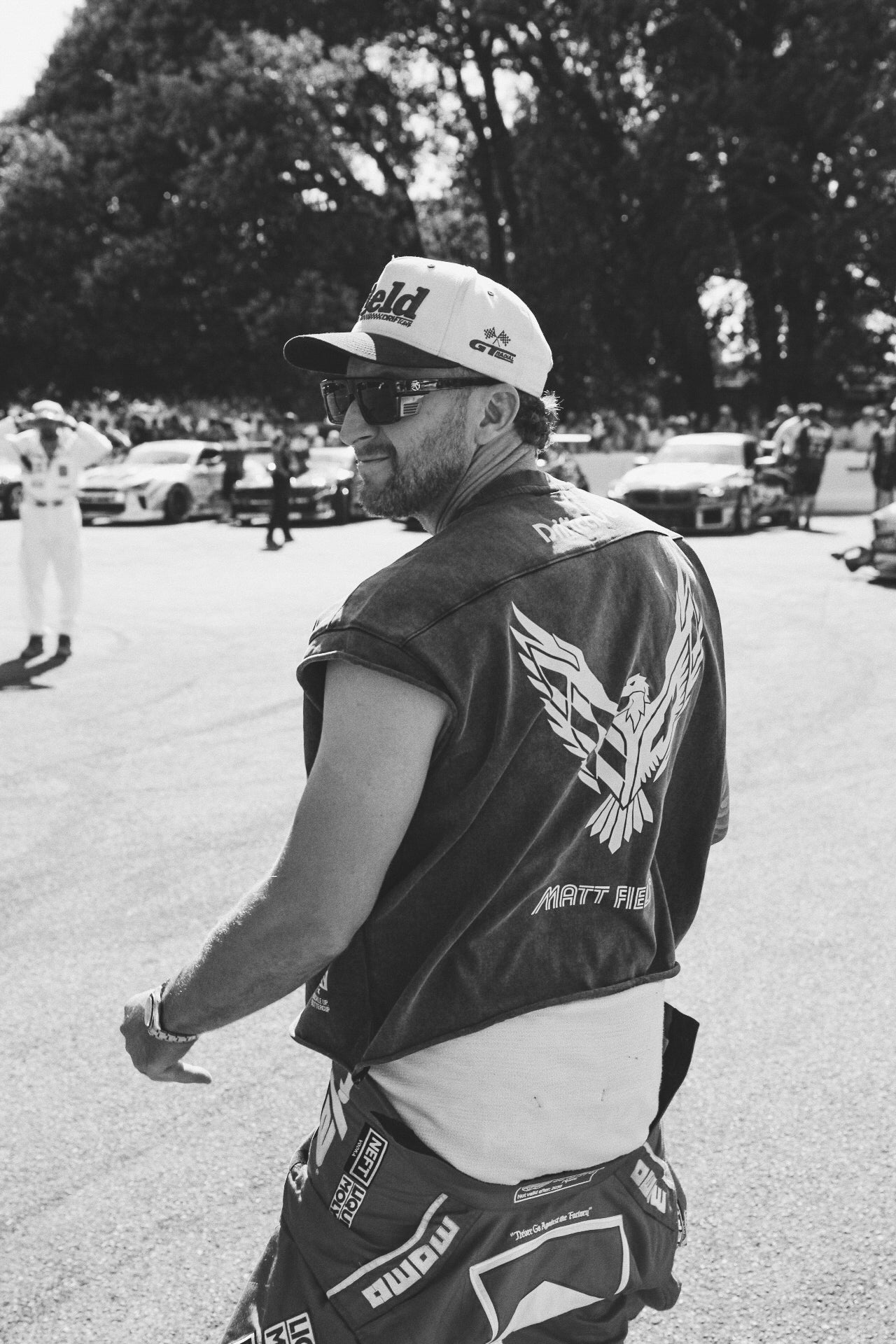 Men's dark crop T-shirt with back wing graphic worn by a male model
