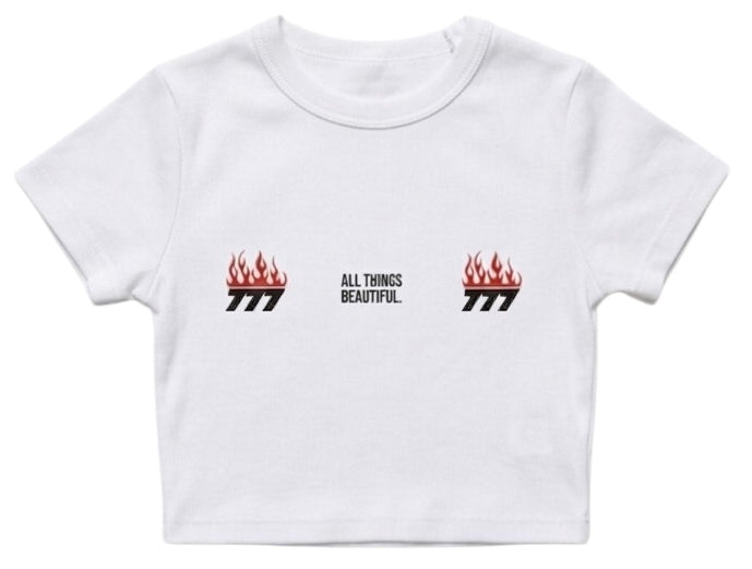 White baby tee with small red flame logos and “ALL THINGS BEAUTIFUL” text