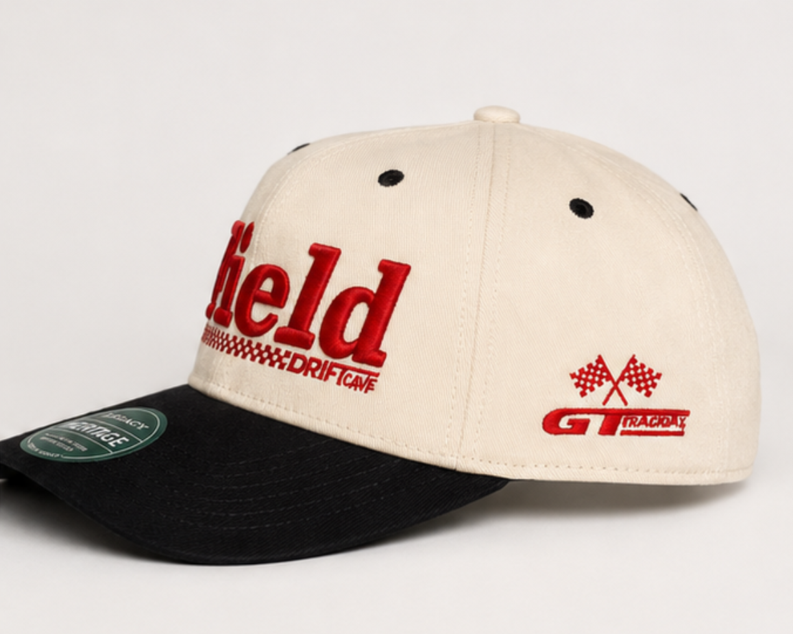 Cream and black baseball cap with 'Field' front logo and red 'GRIP' side mark