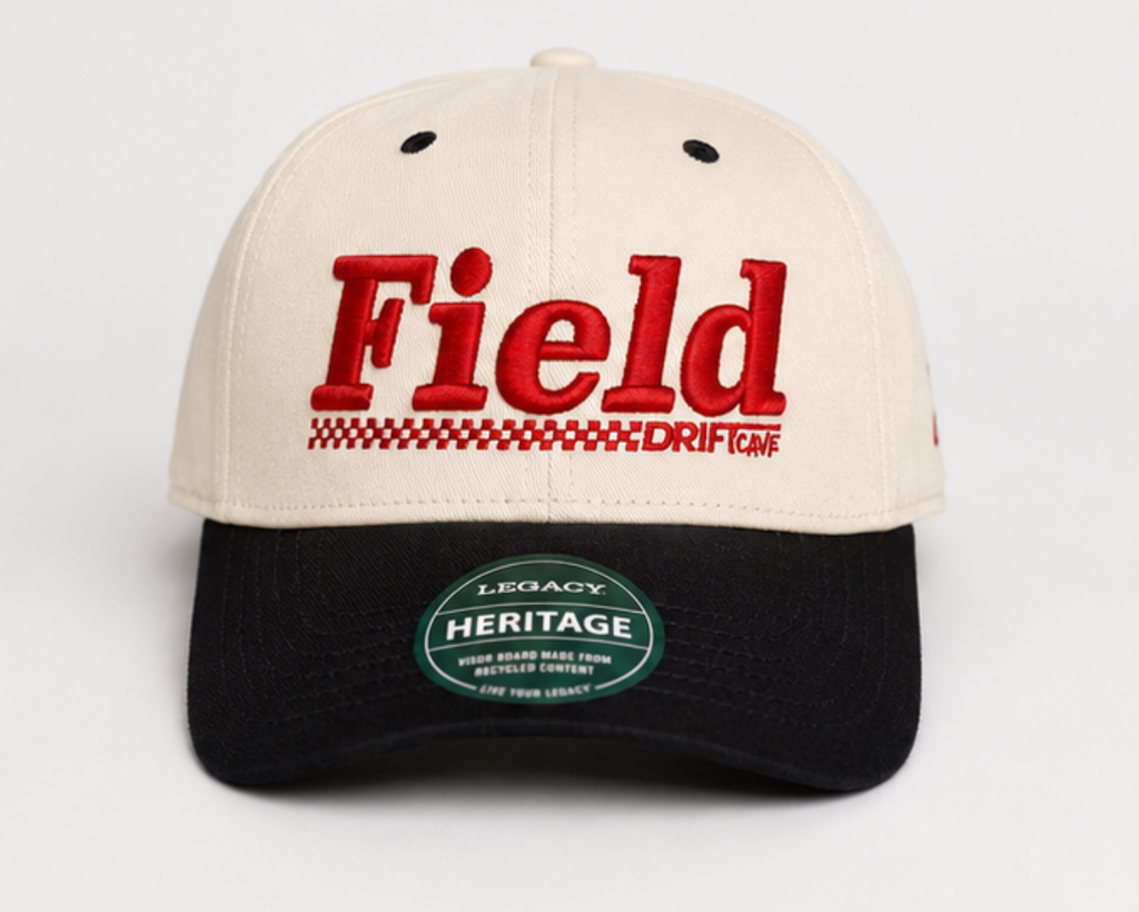 Cream and black baseball cap with 'Field' logo front and green 'Heritage' patch