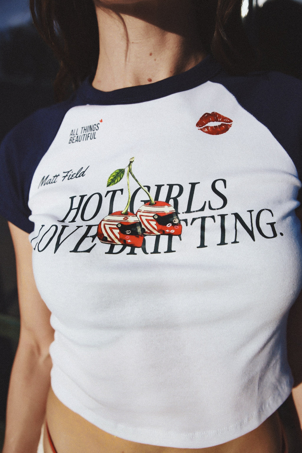 Two-tone navy/white baby tee with 'HOT GIRLS LOVE DRIFTING' graphic and red lips