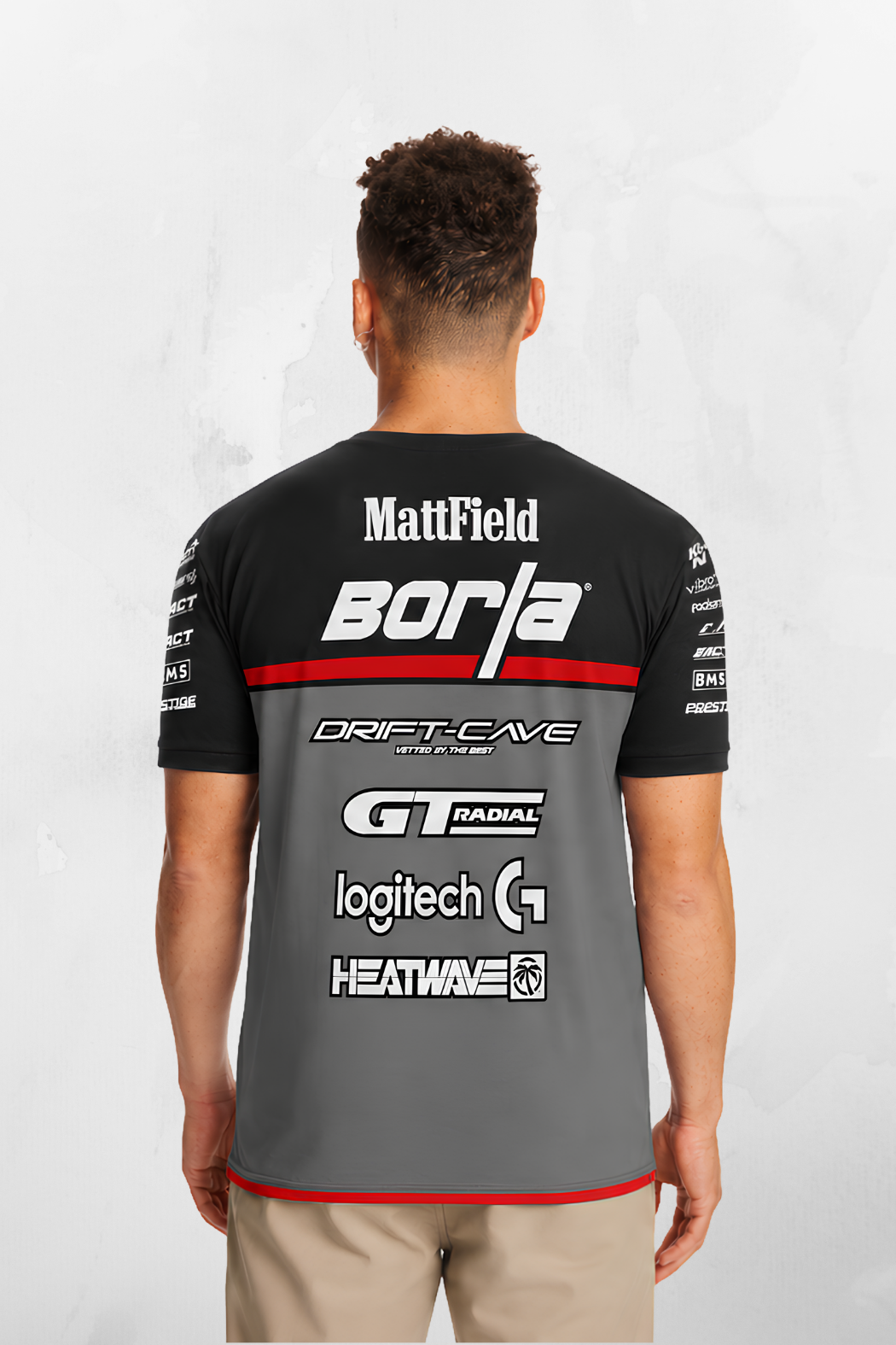 Black team jersey, large back sponsor prints, red trim at hem