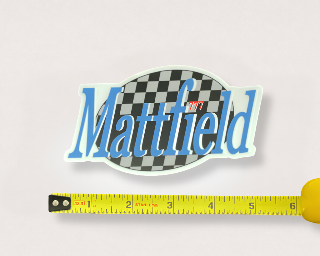 Oval sticker: black-and-white checkerboard, blue 'Matttified' text, red '777' badge.