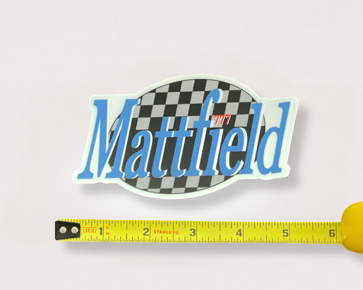Oval sticker: black-and-white checkerboard, blue 'Matttified' text, red '777' badge.